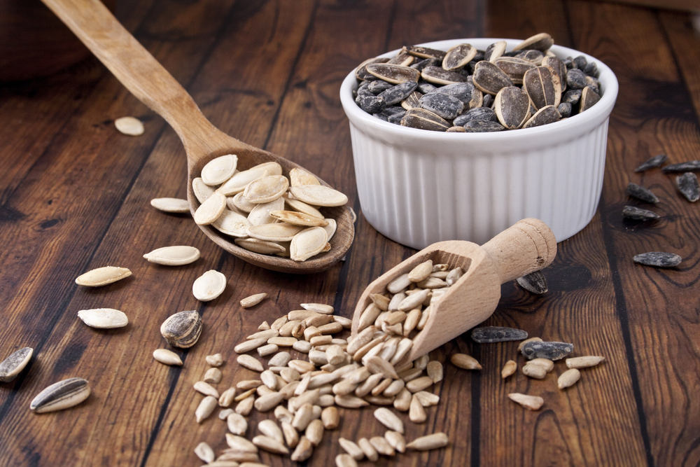 Sunflower,Seeds,And,Pumpkin,Seeds,On,Wood,Background