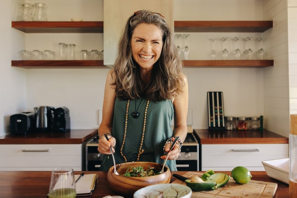 Woman preparing healthy meal - 6 Best Foods for Enhanced Gut Health